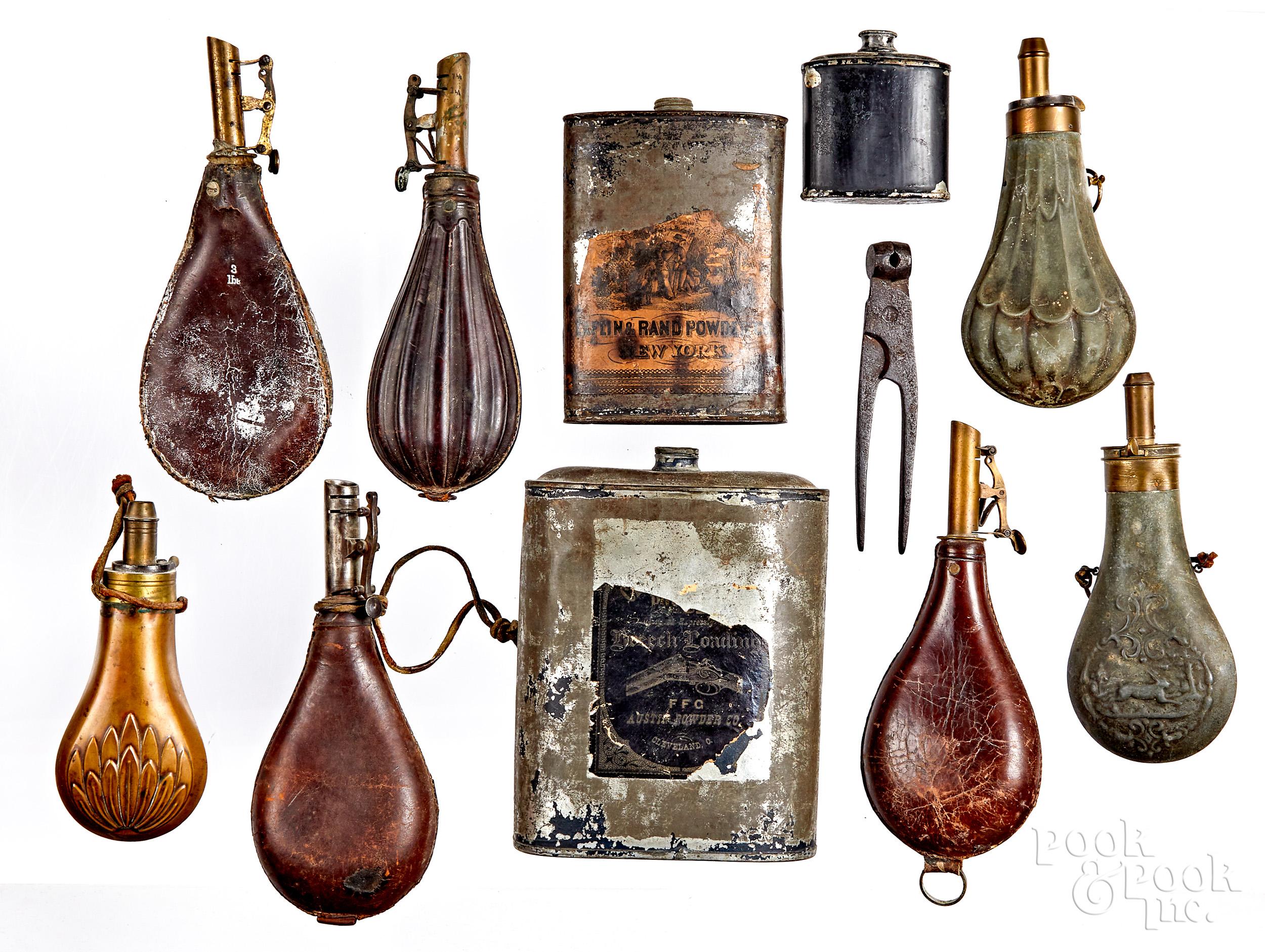 Group of powder flasks and tins