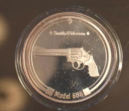 Smith & Wesson, One Troy Oz Silver rounds .999 Fine, One Model 686 Revolver, One 4006 FS Pistol