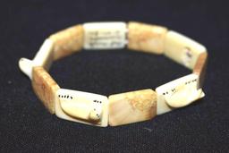 Vintage carved Marine Ivory Bracelet with carved Seals, sign by artist , Pat Omiak Dismede