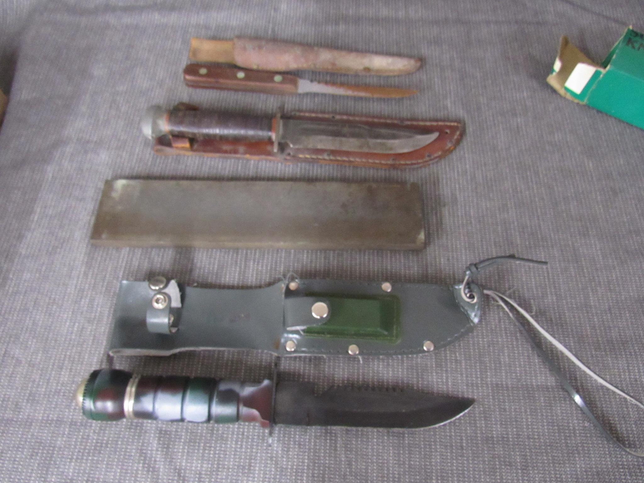 3 fixed blade knives and a sharpening stone.