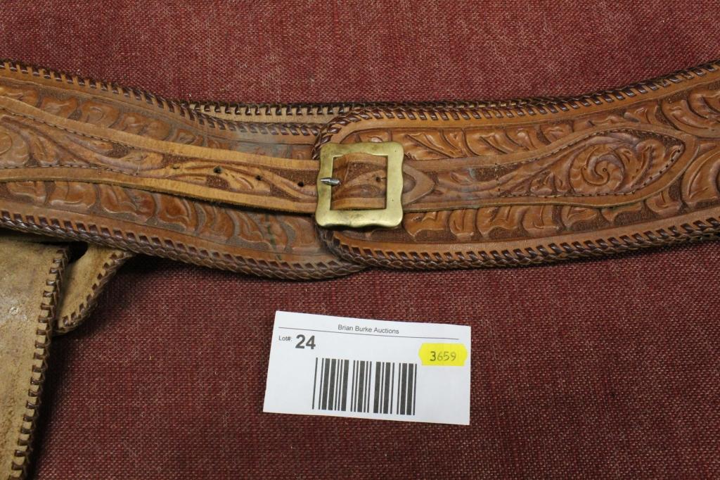 Elaborate leather holster and belt.