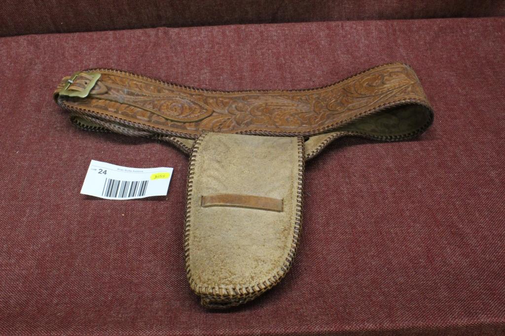 Elaborate leather holster and belt.