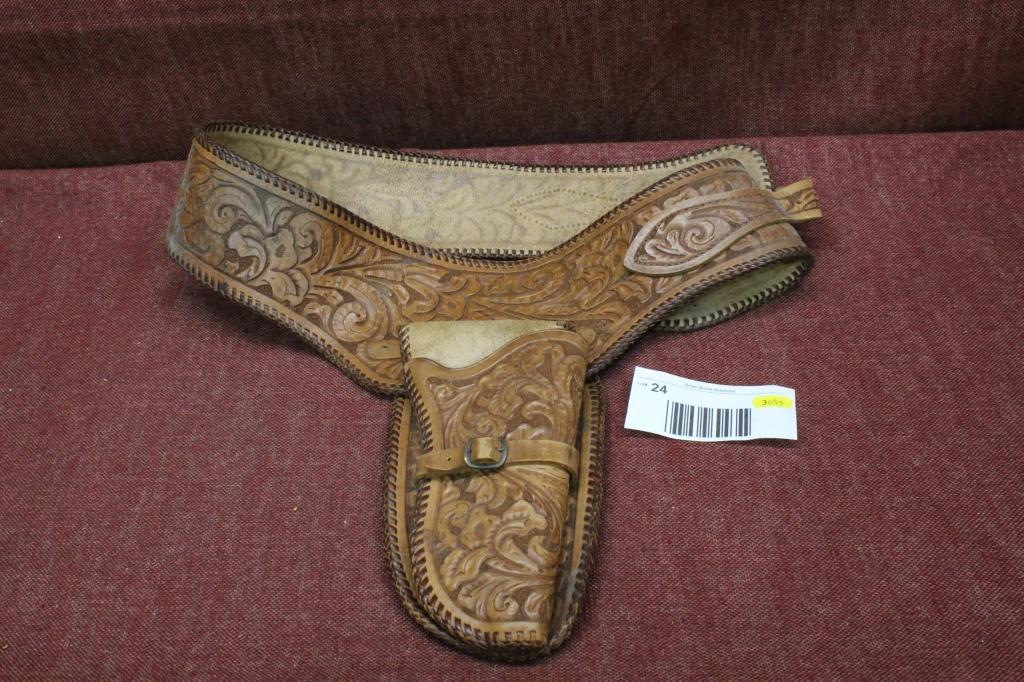 Elaborate leather holster and belt.