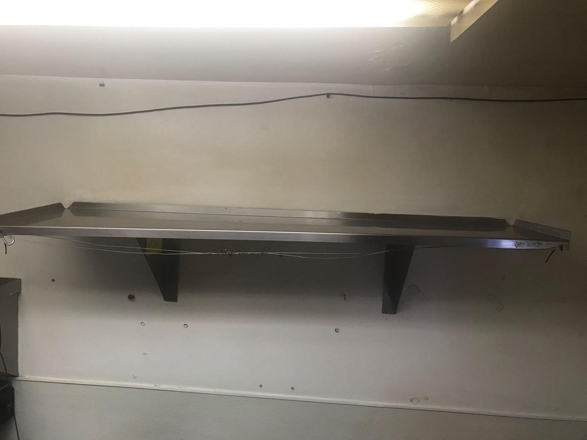 Wall-mounted stainless steel shelf. 48 inches long