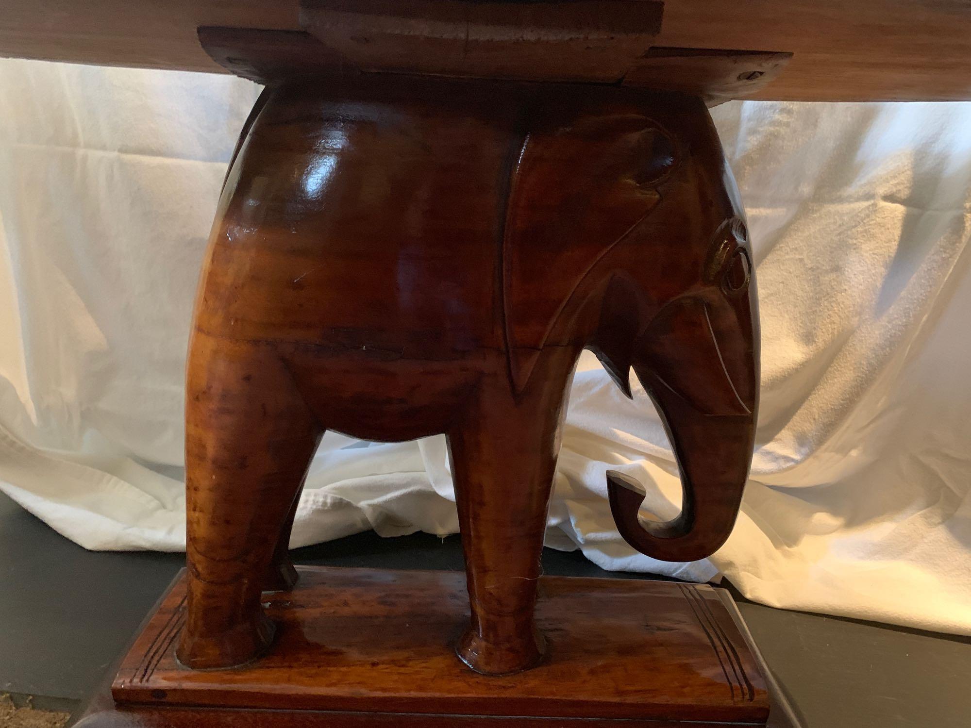 Unique carved Mahogany Elephant based table.