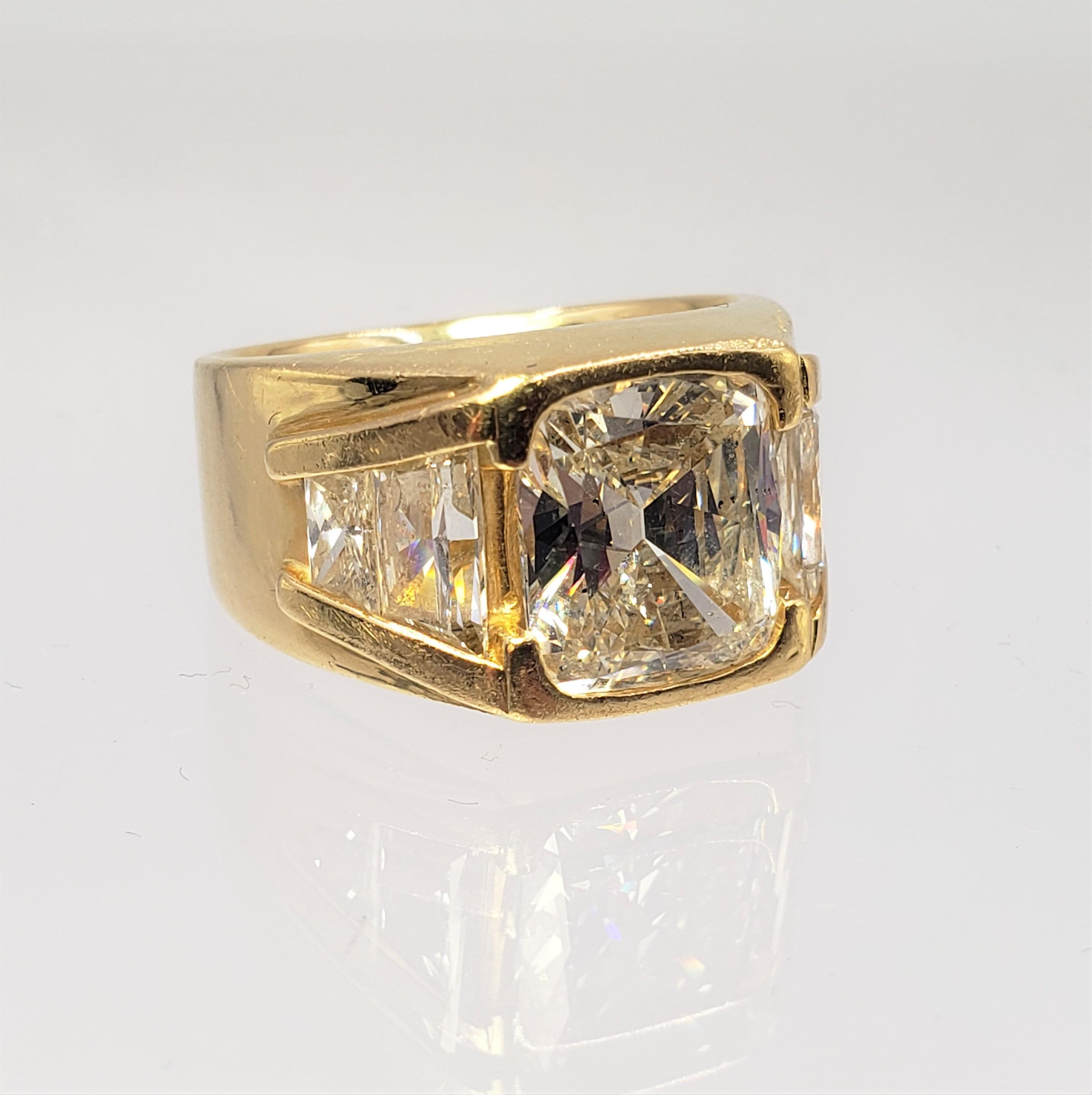 18KT YELLOW GOLD 5.06CT GIA CERTIFIED DIAMOND RING WITH TRAPEZOID CUT SIDE DIAMOND SETTING