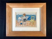 Framed picture depicting of boy washing dog by water