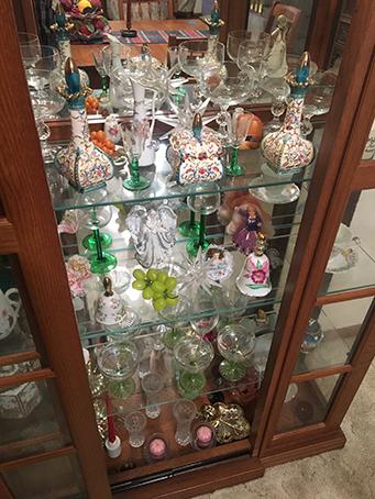 42" x 76" lighted curio cabinet with misc. dishes and figurines