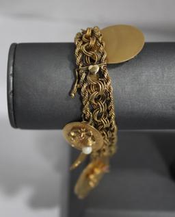 14K Gold Bracelet with 9 14K Charms 63.02g