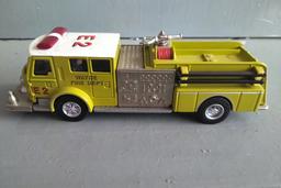 A TUBE OF 12 - 1/64 SCALE FIRE TRUCKS, A 1/64 SCALE POLICE CAR