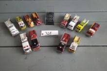 A TUBE OF 12 - 1/64 SCALE FIRE TRUCKS, A 1/64 SCALE POLICE CAR