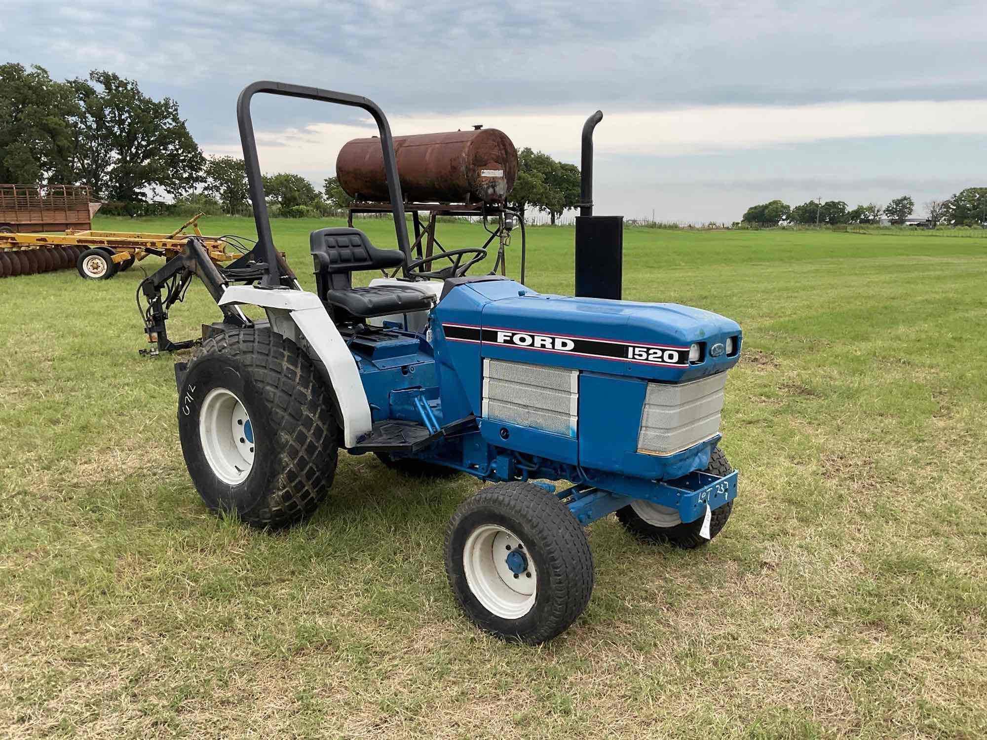 FORD 1520 WITH LOADER DIESEL 2 WHEEL DRIVE BUCKET WITH LOADER TURF TIRES ON THE TRACTOR REAR WEIGHTS