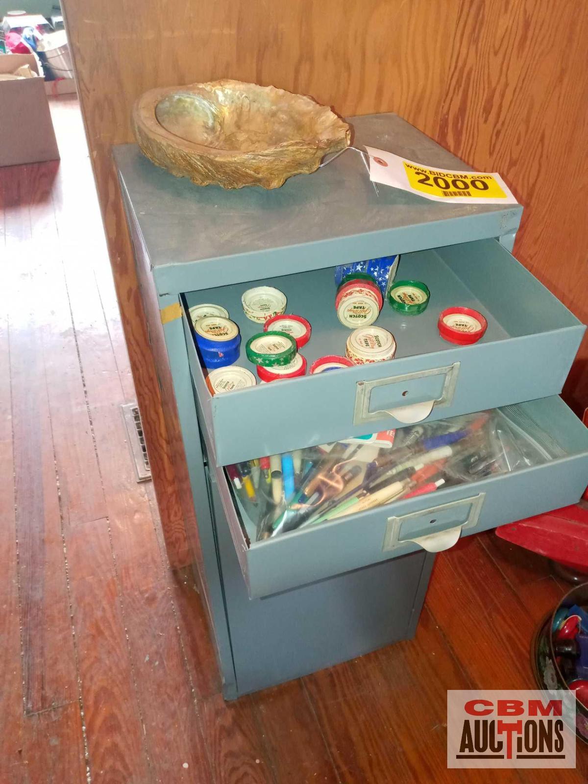 Metal cabinet, assorted pens, decorative tape, staplers and staples, and large shell