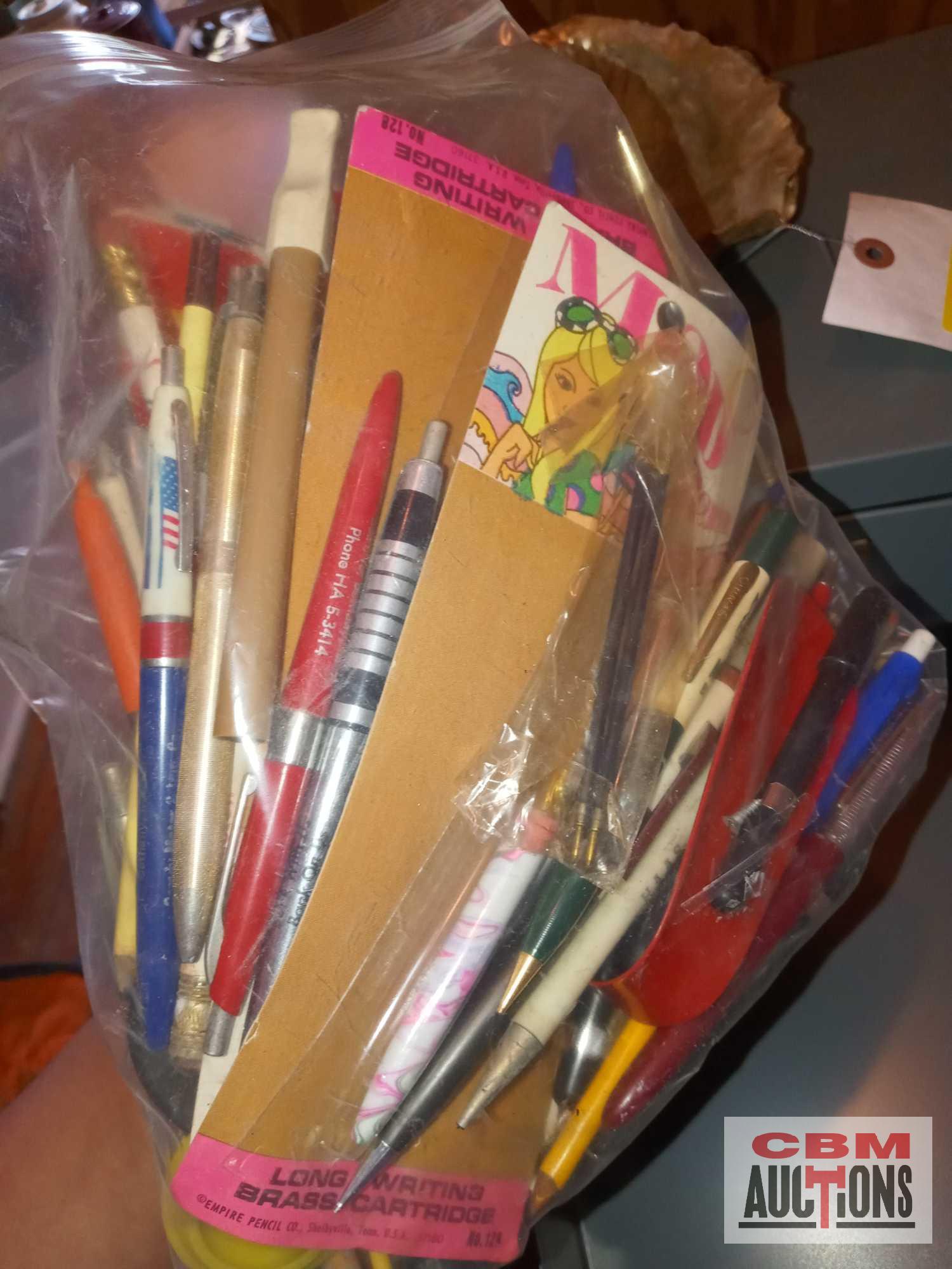 Metal cabinet, assorted pens, decorative tape, staplers and staples, and large shell