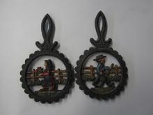PAIR OF CAST IRON TRIVETS AMISH MAN AND WOMAN