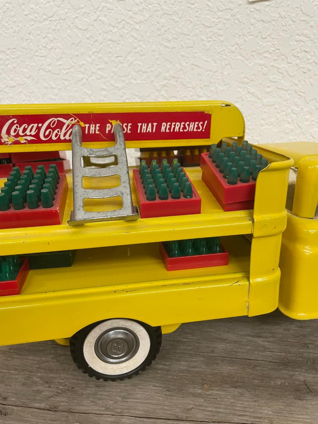 1960s Buddy L yellow Coca-Cola truck with accessories
