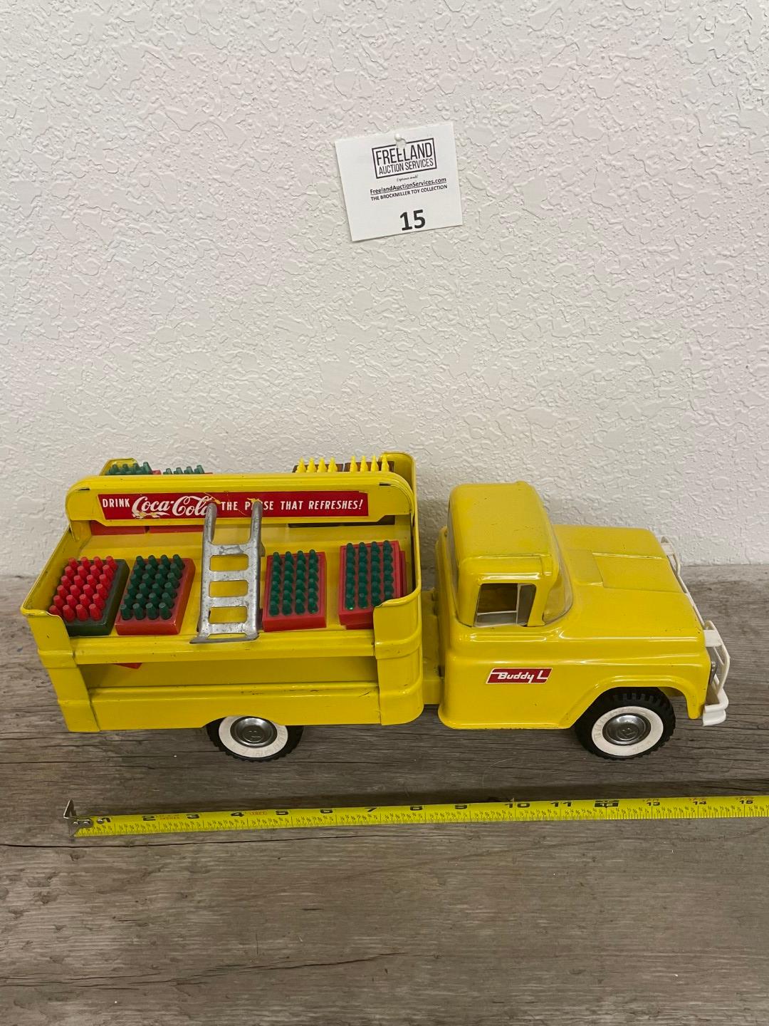 1960s Buddy L yellow Coca-Cola truck with accessories