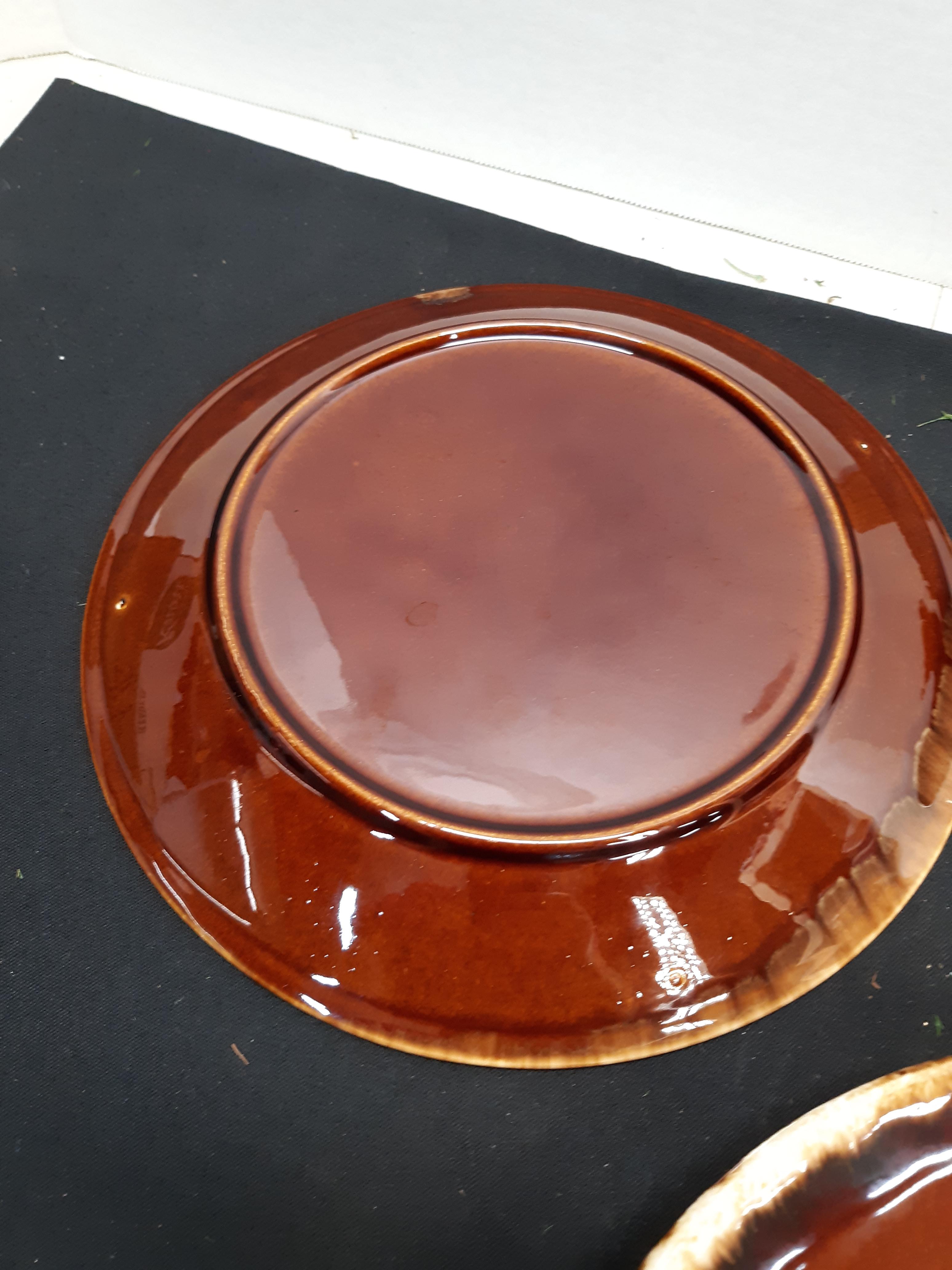 Four brown drip dinner plates