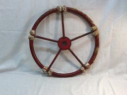Antique rope wrapped metal ships wheel