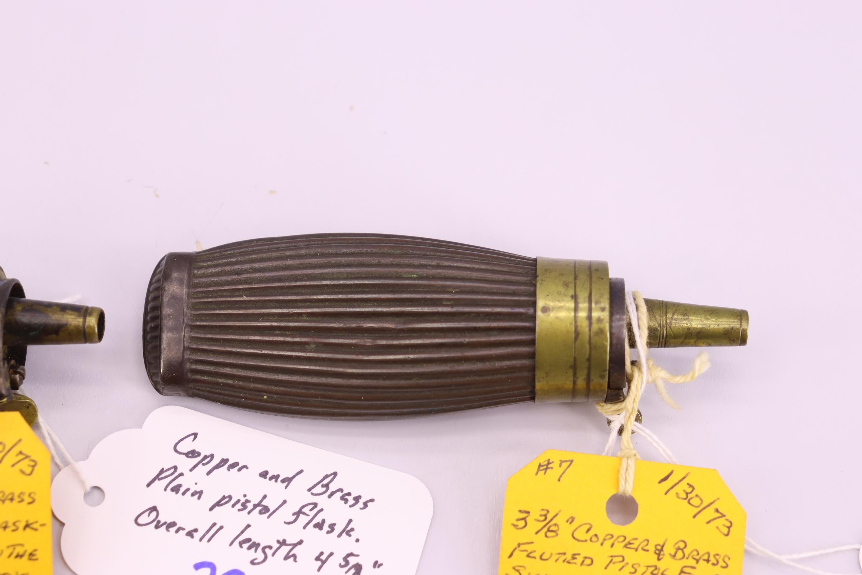 Pair of Powder Flasks – 1st Copper and Brass Fluted Pistol Flask, Overall Length is 4 ½” – 2nd Coppe