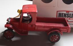 RED CAST IRON TRUCK WITH MAN, HAS PAINT CHIPS