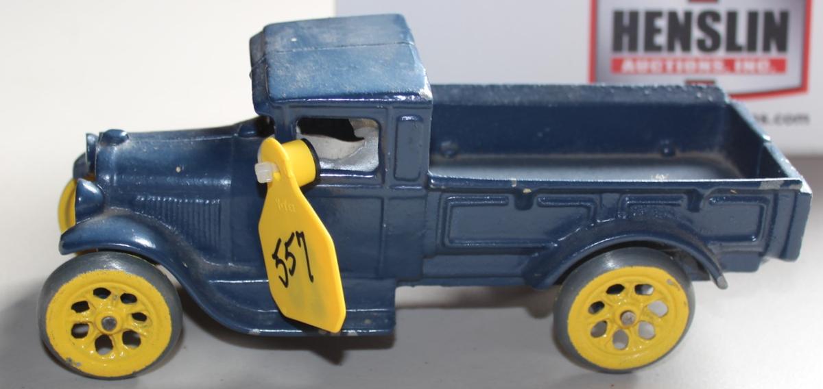 BLUE CAST IRON TRUCK WITH MAN, HAS PAINT CHIPS