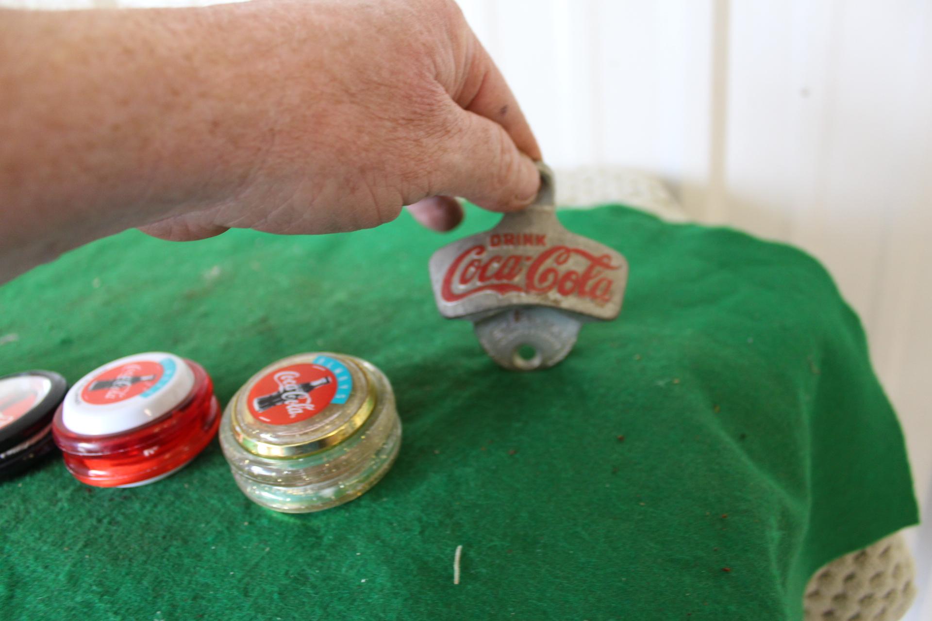 Assorted Coca Cola pieces, straw and napkin holder, yoyo's, lunchbox, jewel