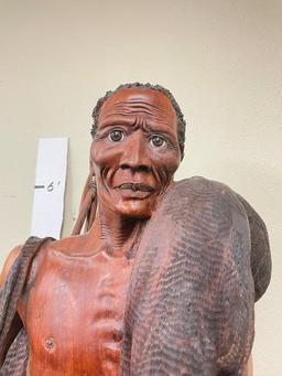 Very detailed wood carving of an African bushman. Carved from one piece of wood by master carver Cha