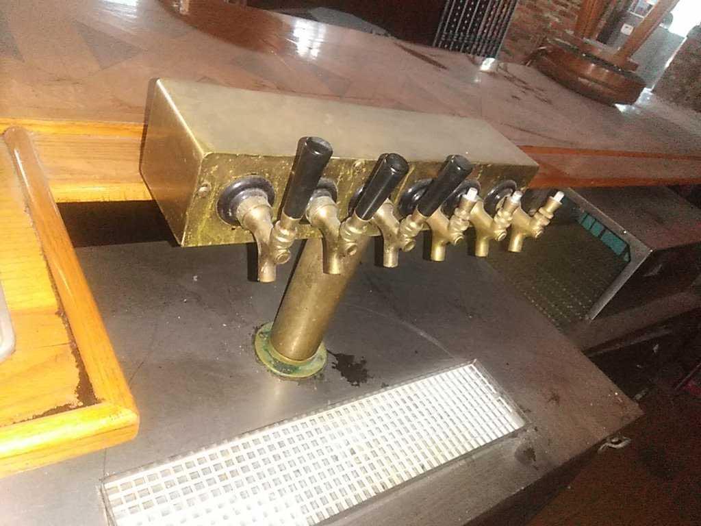 C - Bar with Brass Rails Stools Refrigerators Taps