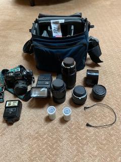 35 millimeter camera with lenses, bag, film and accessories.