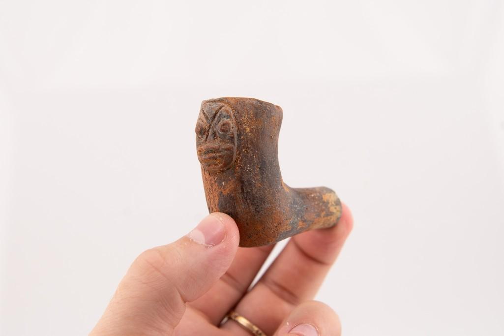 A Ceramic Human Effigy Elbow Pipe