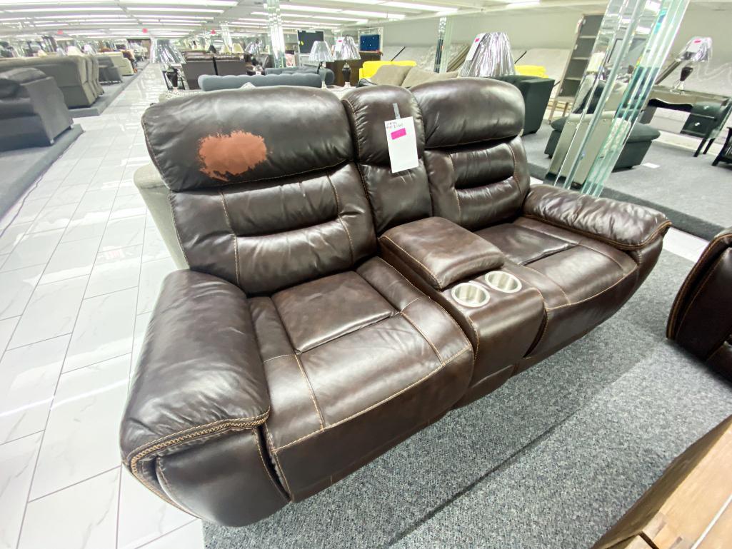 Traditional brown, leather loveseat, with electronic recliners, and middle console with two cupholde