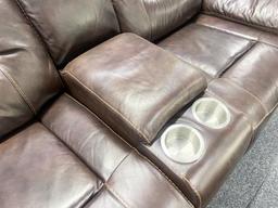 Traditional brown, leather loveseat, with electronic recliners, and middle console with two cupholde