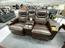 Traditional loveseat with electronic recliners and middle storage console, has 2 cupholders