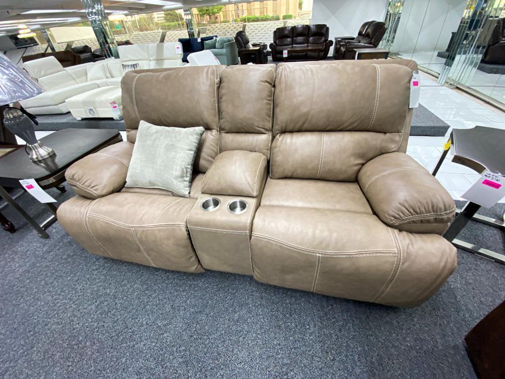 Traditional tan loveseat with electronic recliners and middle storage console, has 2 cupholders