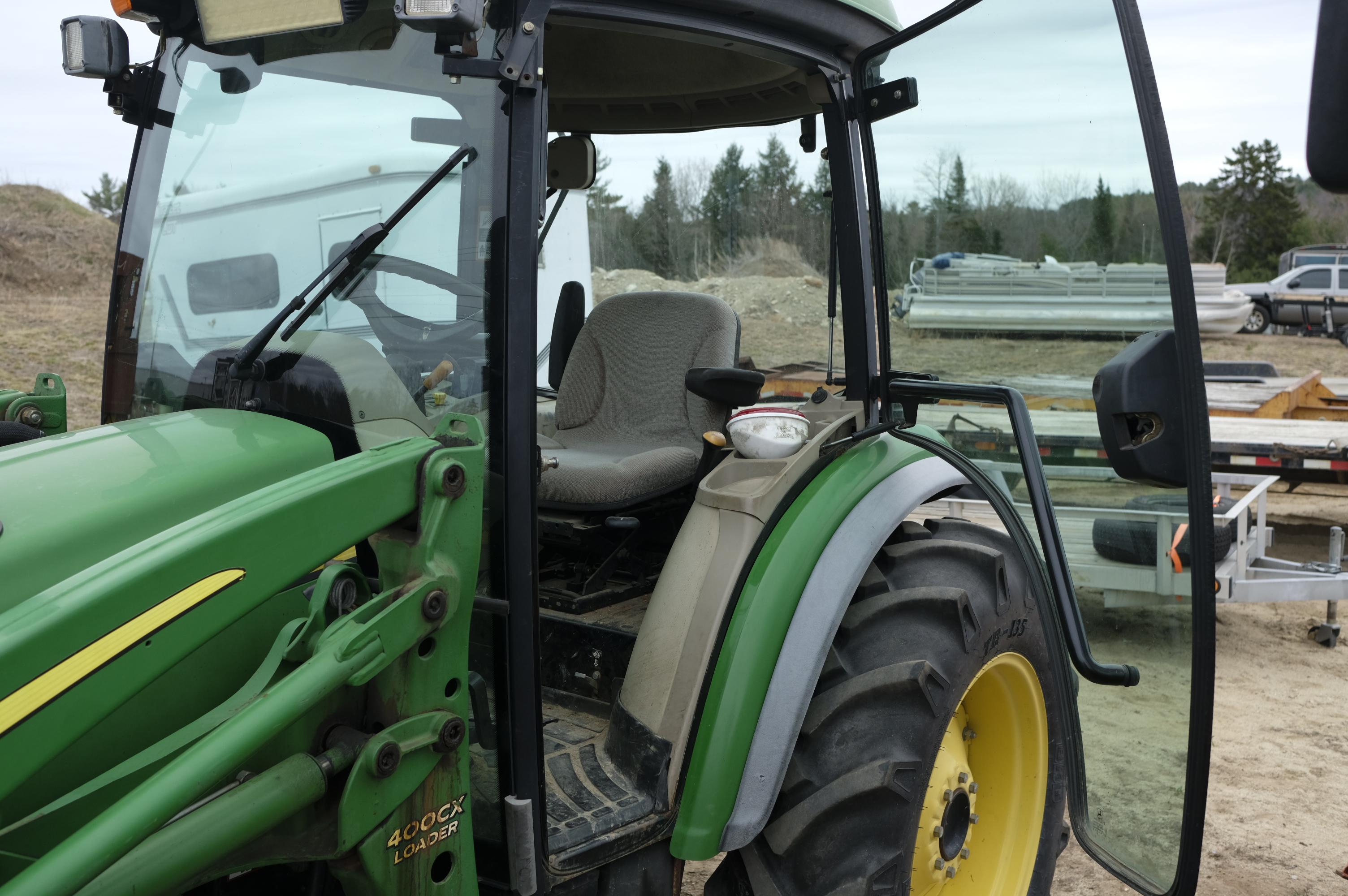 John Deere 4320 tractor with front bucket