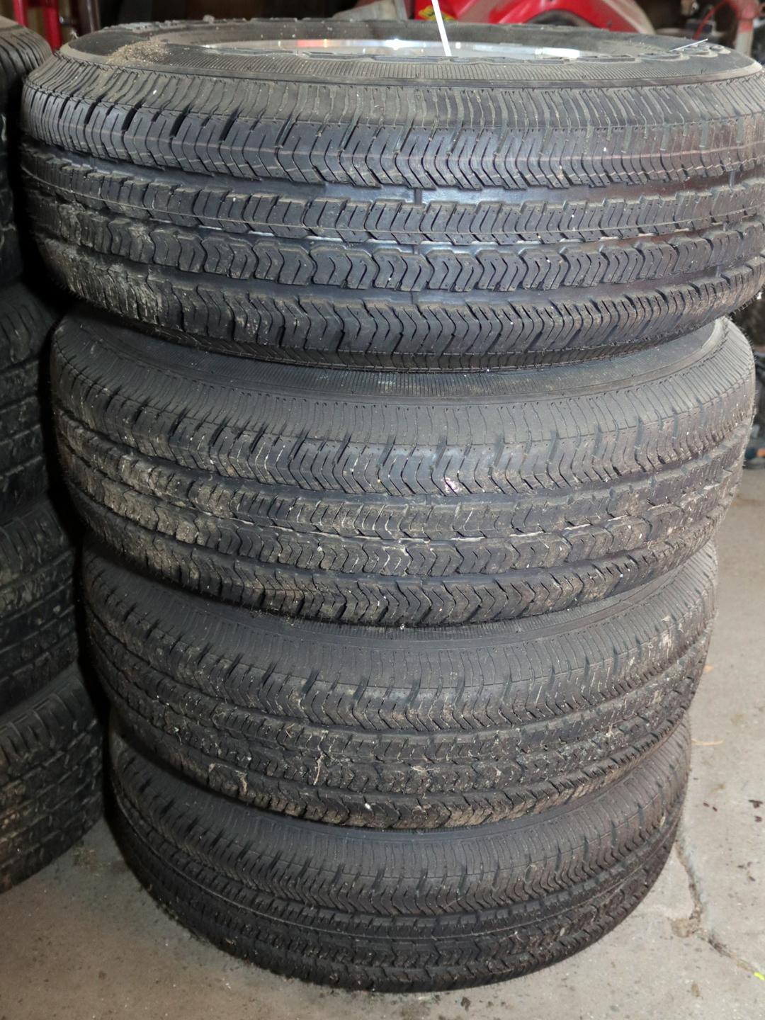 SET OF GOODYEAR WRANGLER ST TIRES W/ ALUMINUM RIMS 225 75R 16, WOULD FIT ON A JEEP