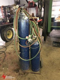 OXYGEN/ACETYLENE TANK CART WITH APPROX. 30' OF HOSE, GOGGLES, TORCH, AND REGULATORS (TANKS ARE BELIE