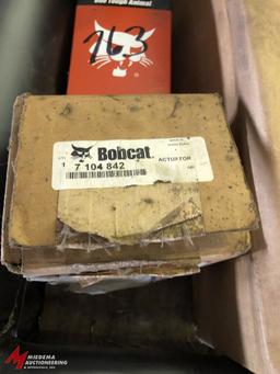 ASSORTED NEW BOBCAT, MODEL 763 PARTS, INCLUDES (2) 6 700 171 CAB CYLINDERS, (1) MUFFLER, (1) PART #7