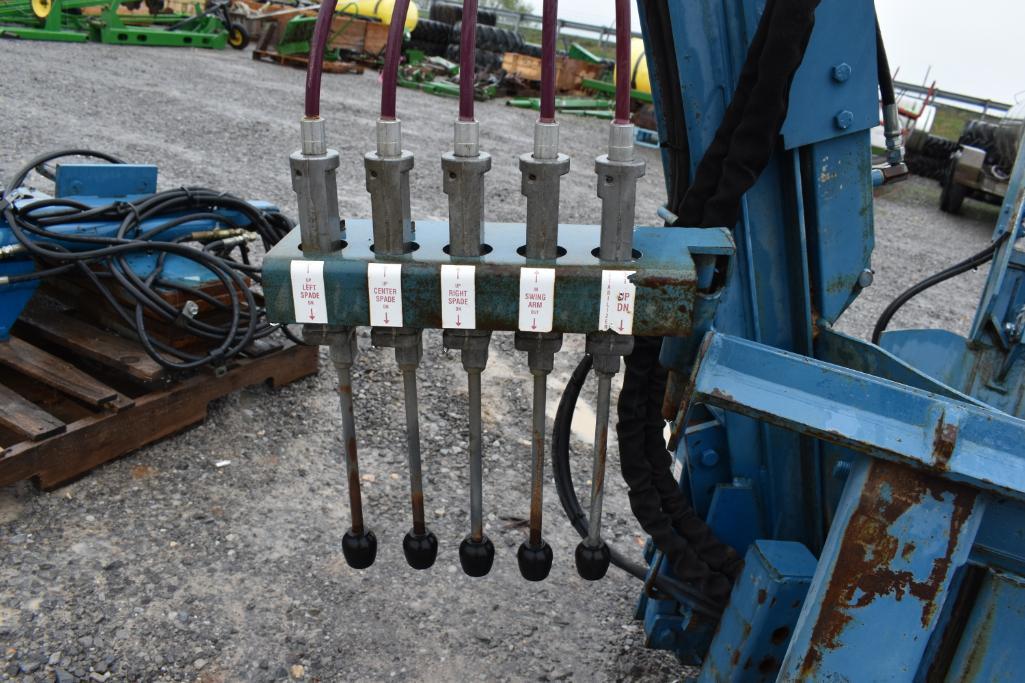 Skid steer mounted tree spade with weights and rear cylinders