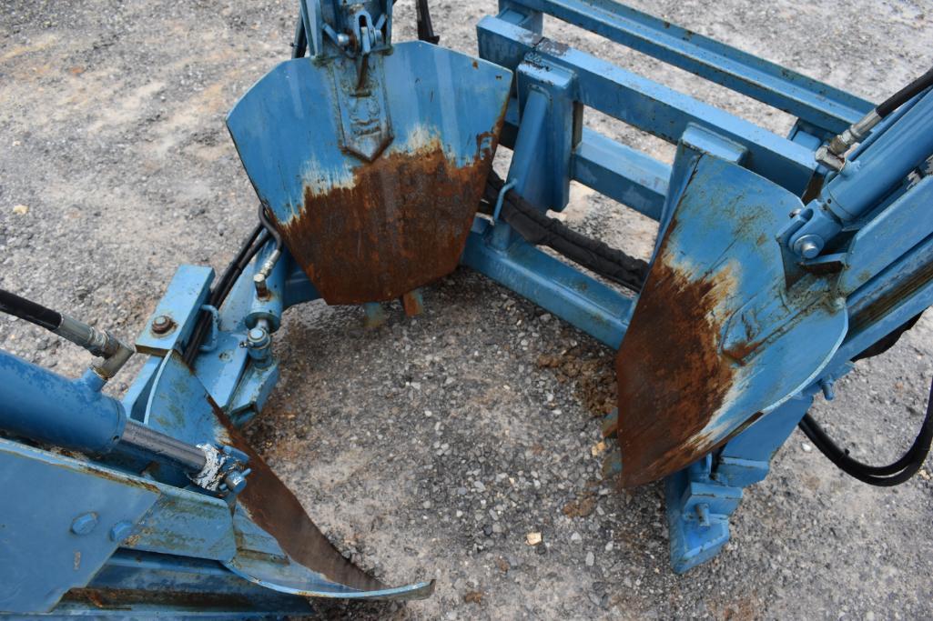 Skid steer mounted tree spade with weights and rear cylinders