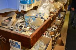 Contents in cabinets & shelves on west wall next to office, items consists of mainly toilet parts &