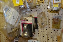 Items on peg board: mainly faucet parts