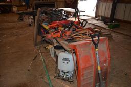 Electric trimmers, older battery charger, grinder, etc. includes wooden table in lot