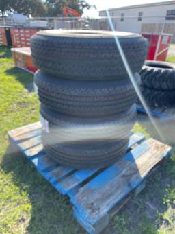 Four Unused ST235/80R16 Trailer Tires and Wheels