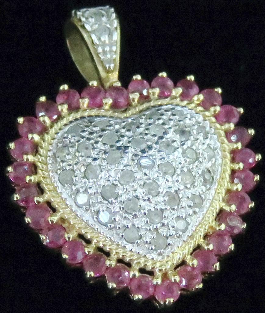 Pendant marked 10K with red & clear stones. Approx 3.1 grams.