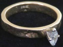 Ring marked 14K with clear stone. Approx 4.2 grams.