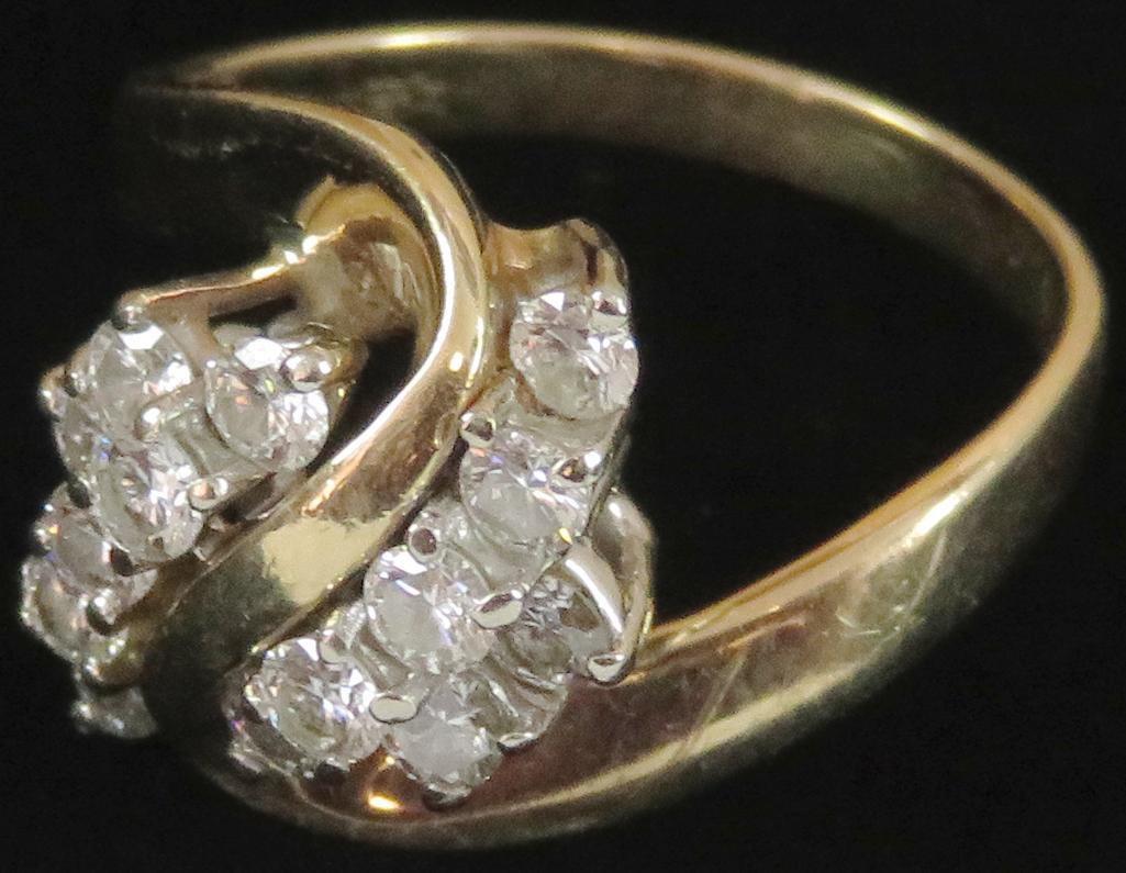 Ring tests 14K with (14) diamonds. Approx 4.8 grams.