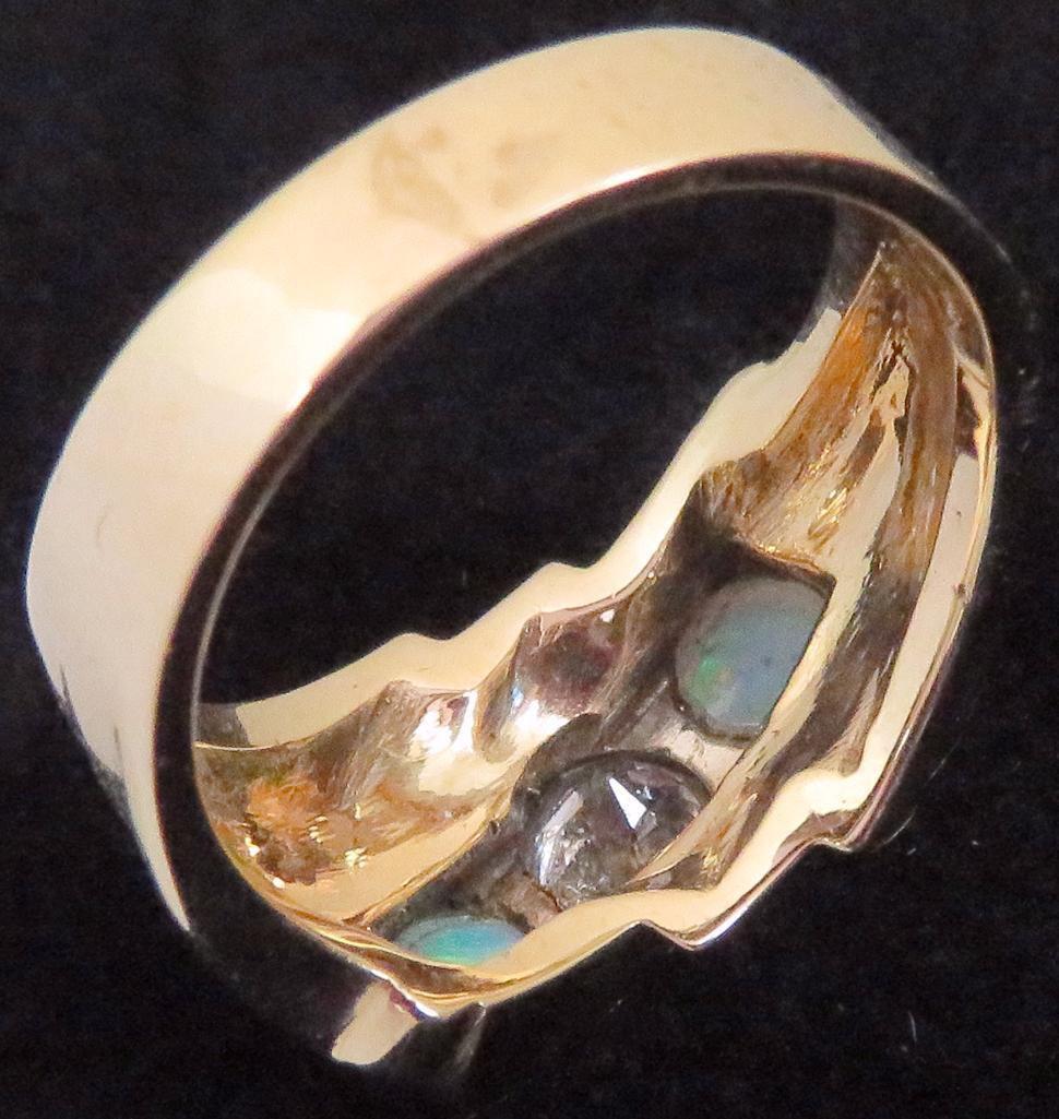 Ring marked 14K with (2) Opals & Diamond. Approx 9.2 grams.