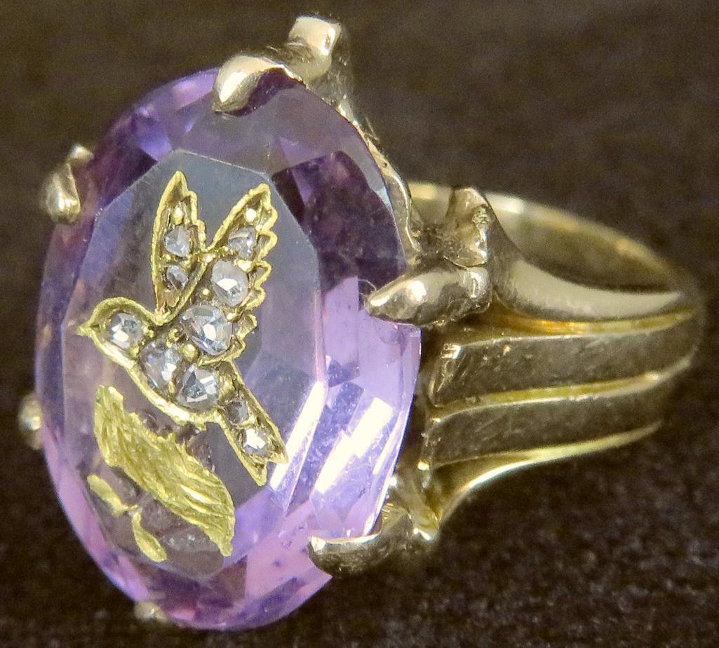 14K Ring with Oval Amethyst approx 4ct. with carved bird inlaid with (10) diamond chips. Approx 8.0